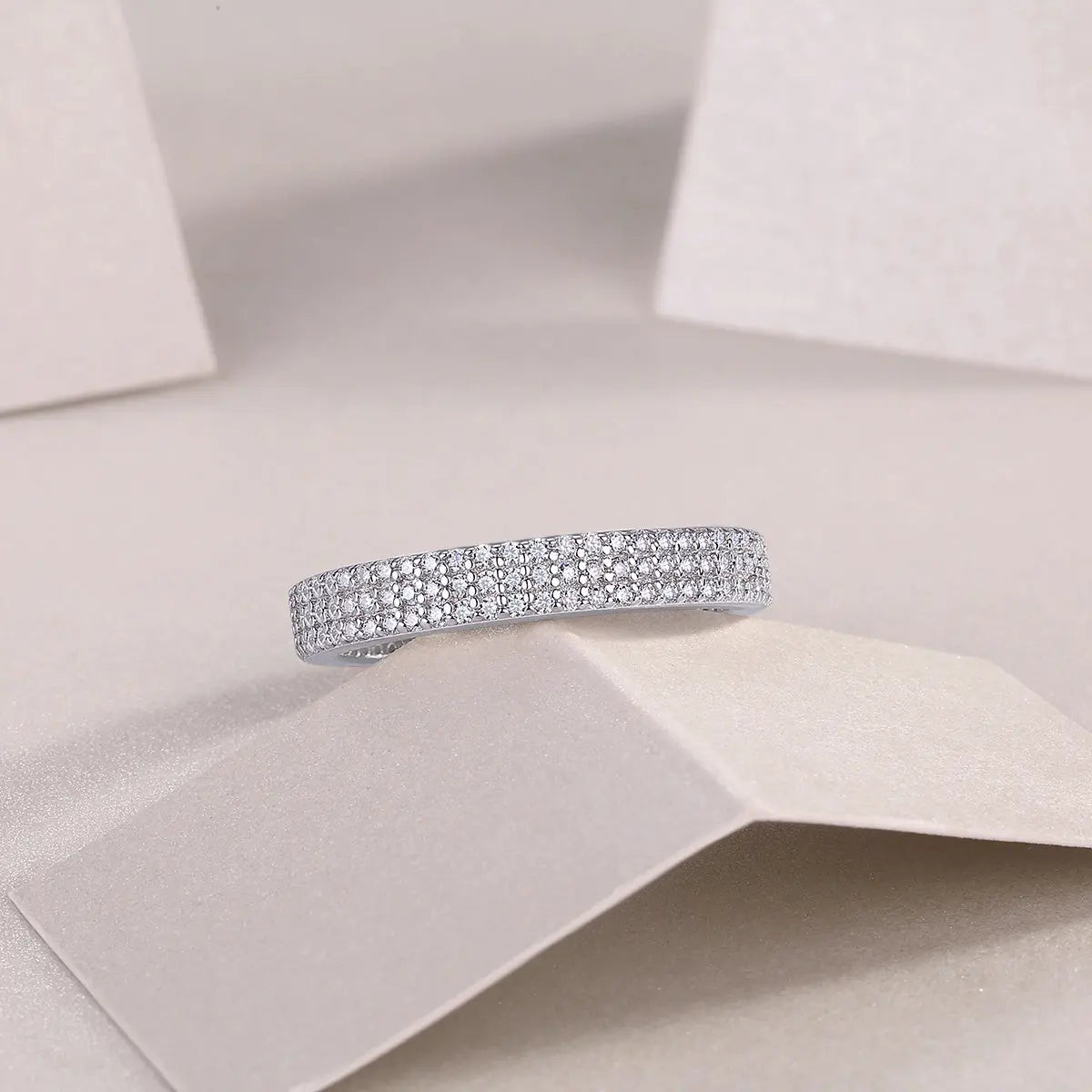 GRA certified moissanite pavé band in rhodium-plated silver
